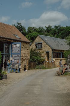 Charming village street with artisan shops and people enjoying the rustic setting.
